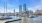 harbor with boats and city skyline in the background